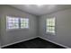 Bright bedroom featuring two large windows, gray walls, and dark wood floors at 4214 Canby Ln, Decatur, GA 30035