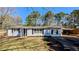 Charming single-story home featuring a brick facade, well-manicured lawn, and a convenient carport at 4214 Canby Ln, Decatur, GA 30035