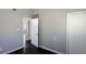 Hallway featuring gray walls, dark wood floors, closet and open doorway at 4214 Canby Ln, Decatur, GA 30035