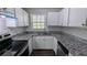 Modern kitchen boasting granite countertops, stainless steel appliances, and ample cabinet space at 4214 Canby Ln, Decatur, GA 30035