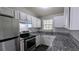 Modern kitchen boasting granite countertops, stainless steel appliances, and ample cabinet space at 4214 Canby Ln, Decatur, GA 30035