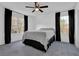 Bright bedroom featuring neutral walls, a ceiling fan, and windows dressed with elegant, dark curtains at 708 Mill Pond Se Dr, Smyrna, GA 30082