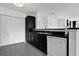 Contemporary kitchen featuring sleek black cabinetry, white appliances, and ample storage space at 708 Mill Pond Se Dr, Smyrna, GA 30082