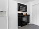 Well-equipped kitchen boasts black appliances, microwave, and convenient closet storage space at 708 Mill Pond Se Dr, Smyrna, GA 30082