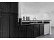 Modern kitchen showcasing black cabinets, stainless steel sink, and open layout into the living area at 708 Mill Pond Se Dr, Smyrna, GA 30082