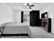 Comfortable bedroom featuring a ceiling fan, brick fireplace, TV, and carpeted floor at 708 Mill Pond Se Dr, Smyrna, GA 30082