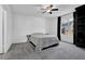 Cozy bedroom with neutral tones, ceiling fan, carpeted floor, and window with black curtain at 708 Mill Pond Se Dr, Smyrna, GA 30082