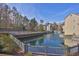 Picturesque pond with a fountain, bridge, and surrounding greenery next to residential buildings at 708 Mill Pond Se Dr, Smyrna, GA 30082