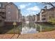 Scenic view of a pond between buildings and a fountain in the distance with a no fishing sign at 708 Mill Pond Se Dr, Smyrna, GA 30082