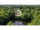 A stunning aerial shot showcases a home nestled among a lush forest, with a scenic pond providing a tranquil backdrop at 144 Bobs Sw Dr, Mableton, GA 30126