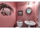 Pink bathroom featuring a toilet and sink at 144 Bobs Sw Dr, Mableton, GA 30126