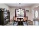 Cozy dining room with wood table set beneath a vintage-style chandelier and adjacent to cabinet with glass doors at 144 Bobs Sw Dr, Mableton, GA 30126