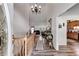 Inviting foyer with high ceilings, wood floors, chandelier, and a view into the living spaces at 144 Bobs Sw Dr, Mableton, GA 30126