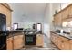 Bright kitchen featuring wood cabinets, black appliances, and an open layout for easy entertaining at 144 Bobs Sw Dr, Mableton, GA 30126