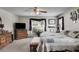 Bright main bedroom with a large window, bench seat, and traditional furnishings at 144 Bobs Sw Dr, Mableton, GA 30126