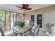 Screened porch featuring an outdoor dining set and a fan at 144 Bobs Sw Dr, Mableton, GA 30126