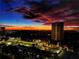 The city skyline at night, with warm lights from buildings glowing against a dramatic sky at 2870 Pharr Court South Nw # 2402, Atlanta, GA 30305