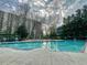 Large outdoor swimming pool with sun loungers, landscaping, and tall building in the background at 2870 Pharr Court South Nw # 2402, Atlanta, GA 30305