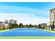 A vibrant blue and green tennis court overlooks city buildings with a clear blue sky backdrop at 2870 Pharr Court South Nw # 2402, Atlanta, GA 30305