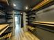 Walk-in closet with custom dark metal and light wood shelving at 2870 Pharr Court South Nw # 2402, Atlanta, GA 30305