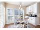 Inviting breakfast nook featuring a round table, white chairs, custom cabinets, and plantation shutters at 359 Flatstone Sw Way, Marietta, GA 30064