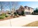 Brick home featuring 3-car garage, mature landscaping and shrubbery at 359 Flatstone Sw Way, Marietta, GA 30064