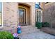 Charming brick home entrance with an arched doorway and brick paver pathway at 359 Flatstone Sw Way, Marietta, GA 30064