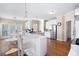 Bright kitchen features white cabinets, a breakfast bar, stainless steel appliances, and wood floors at 359 Flatstone Sw Way, Marietta, GA 30064