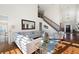 Spacious living room with a staircase, fireplace, and plush seating arrangement, enhanced by natural light at 359 Flatstone Sw Way, Marietta, GA 30064