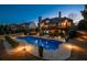 Backyard oasis featuring a sparkling pool, patio area, and lush landscape in the evening at 359 Flatstone Sw Way, Marietta, GA 30064