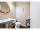 Small powder room featuring pedestal sink, toilet and wood-look floors at 359 Flatstone Sw Way, Marietta, GA 30064