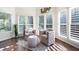 Sun-drenched sitting room with hardwood floors and plantation shutters at 359 Flatstone Sw Way, Marietta, GA 30064