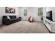 Cozy living room featuring carpet flooring, two windows, sofa, and TV at 3479 Jasmine Sw Way, Atlanta, GA 30331