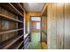 Hallway with wood paneling and built-in shelving, leading to a bedroom at 94 Gilley Rd, Carrollton, GA 30116