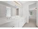 Bathroom featuring double sinks, a large mirror, and view to bedroom at 1139 Tennyson Ne Pl, Brookhaven, GA 30319
