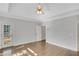 Bright bedroom showcasing hardwood floors, a ceiling fan, and a private patio door at 1139 Tennyson Ne Pl, Brookhaven, GA 30319