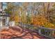 Spacious wooden deck with railing offers a private outdoor retreat with scenic views of the fall foliage at 1139 Tennyson Ne Pl, Brookhaven, GA 30319