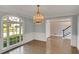 Elegant dining room features a chandelier, large window, and wainscoting at 1139 Tennyson Ne Pl, Brookhaven, GA 30319
