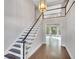Entry way with a staircase and beautiful chandelier, leading to an area with lots of natural light at 1139 Tennyson Ne Pl, Brookhaven, GA 30319