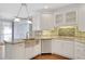 Kitchen with stainless steel appliances, including an island sink, and white cabinets at 1139 Tennyson Ne Pl, Brookhaven, GA 30319