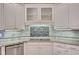 Bright kitchen features custom white cabinets, sleek stovetop, and elegant granite countertops at 1139 Tennyson Ne Pl, Brookhaven, GA 30319