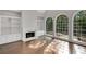Living room with a fireplace, bookshelves, and large windows that provide lots of natural light at 1139 Tennyson Ne Pl, Brookhaven, GA 30319