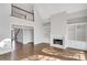 Living room with a fireplace and bookshelves, next to an area with a staircase at 1139 Tennyson Ne Pl, Brookhaven, GA 30319