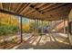 Covered patio with view of colorful fall foliage and wooden stairs at 1139 Tennyson Ne Pl, Brookhaven, GA 30319