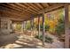 Covered patio overlooking a yard with colorful foliage during fall at 1139 Tennyson Ne Pl, Brookhaven, GA 30319