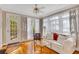 Cozy room featuring hardwood floors, white sofa and chairs and multiple windows and natural light at 1139 Tennyson Ne Pl, Brookhaven, GA 30319