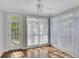 Sunroom with large windows covered by white curtains, and a door that leads to a deck at 1139 Tennyson Ne Pl, Brookhaven, GA 30319
