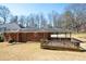 Backyard view showing the deck and a covered patio extending from the brick home at 1276 Kingsview Se Cir, Smyrna, GA 30080
