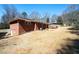 Backyard view of a brick home with an expansive lawn, showcasing ample outdoor space and a well-maintained exterior at 1276 Kingsview Se Cir, Smyrna, GA 30080