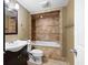 Bathroom with tiled shower-tub combo, dark vanity, and neutral decor, combining functionality with style at 1276 Kingsview Se Cir, Smyrna, GA 30080